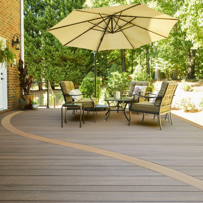 TimberTech Azek Vintage Collection deck in Mahogany and Cypress featuring a multi-level layout, mitered corners, and integrated LED stair lighting.