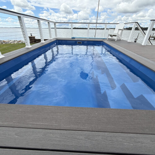Luxury fiberglass pool installation in Rehoboth Beach, DE by Coastal Outdoor Living.