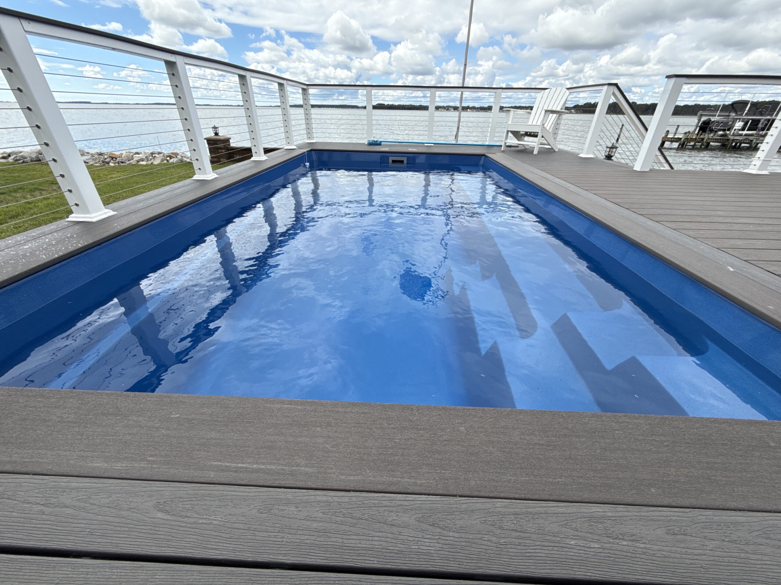 Luxury fiberglass pool installation in Rehoboth Beach, DE by Coastal Outdoor Living.