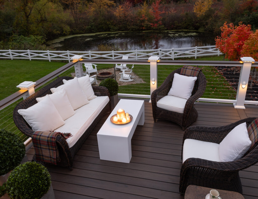 TimberTech Mocha Legacy Collection composite deck with white railings and built-in post cap lighting.