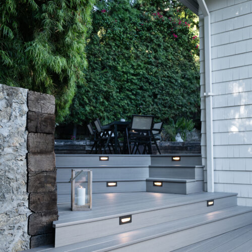Close-up of recessed LED riser lights on a TimberTech Landmark Castle Gate composite deck.